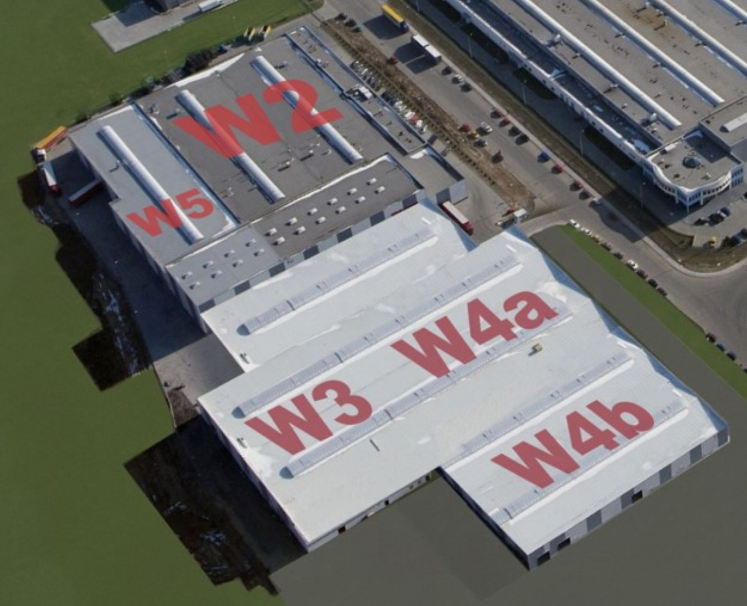 Luftaufnahme eines großen Industriekomplexes mit den beschrifteten Abschnitten W2, W3, W4a, W4b und W5, umgeben von Straßen und Grünanlagen.